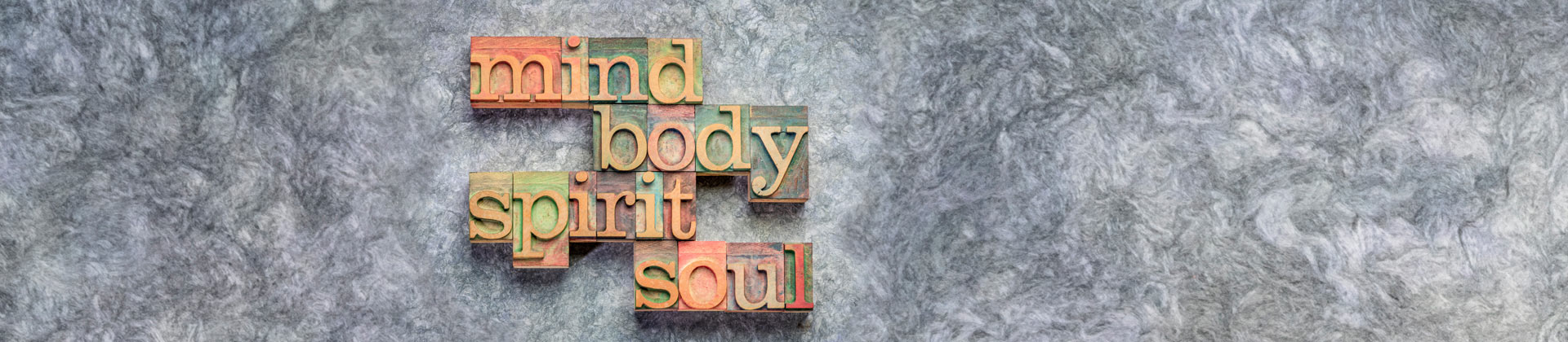 Mind Body Spirit Soul - words carved on wooden blocks